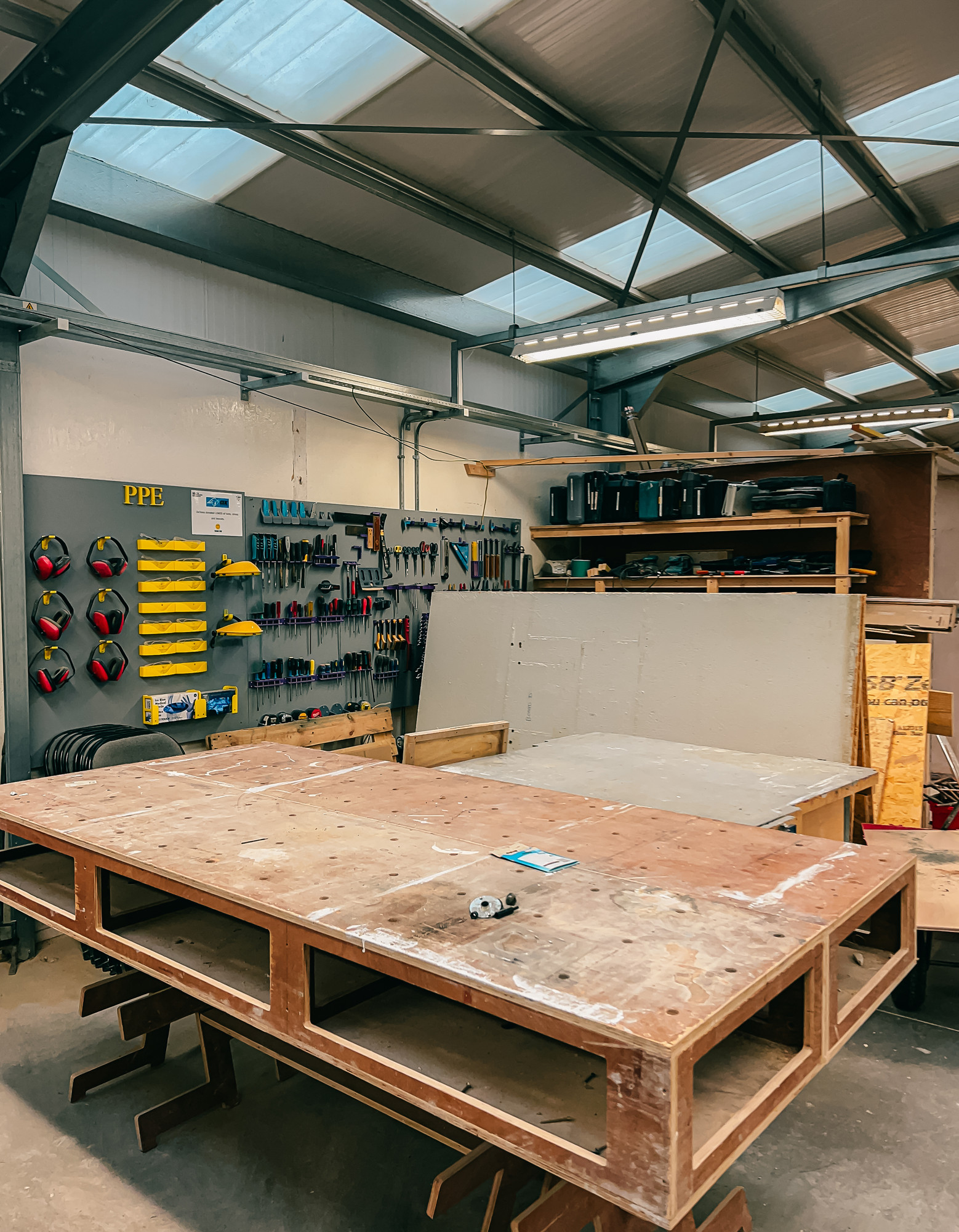 A large workshop of tools and a large wooden working palette