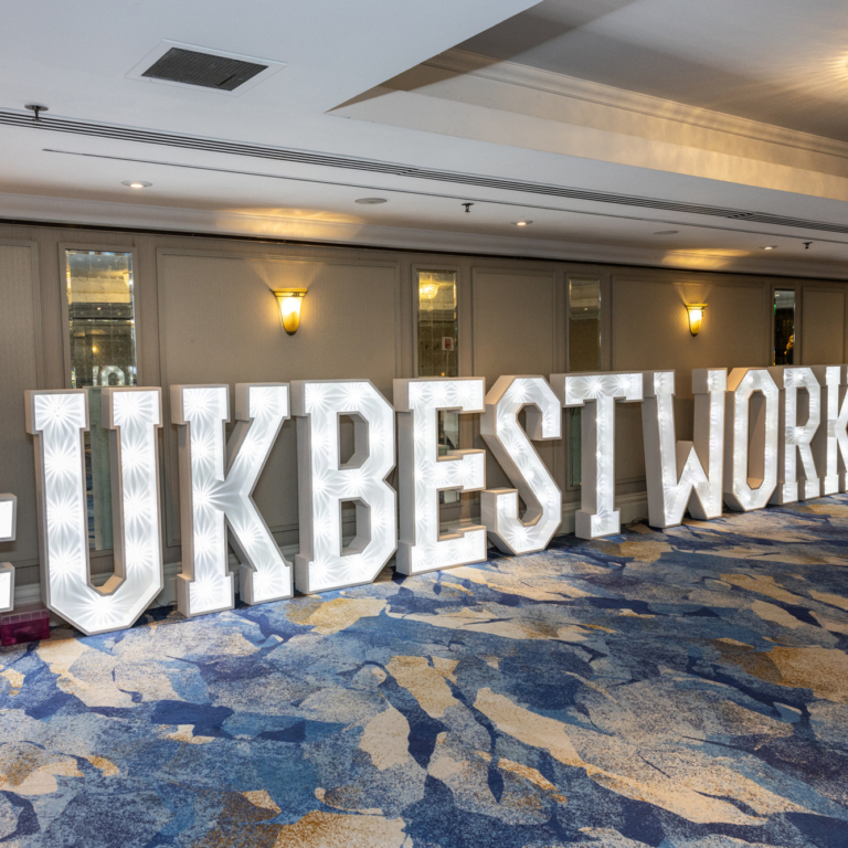 UK BEST WORK PLACES in light up, 4ft high letters lining the wall of the ceremony location