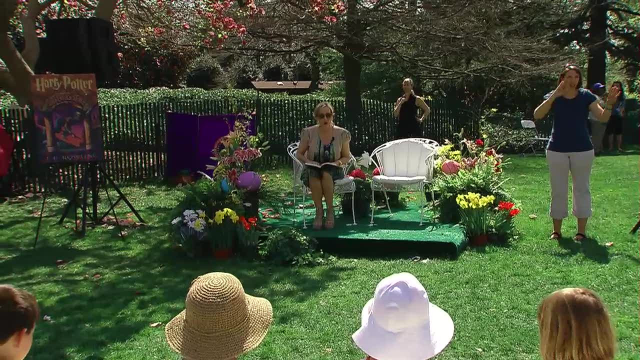JK Rowling reads from Harry Potter in a garden to a small audience