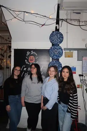 4 women pose for the camera on a work social in smart casual wear