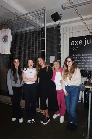 A group of 5 women pose for the camera in smart casual wear