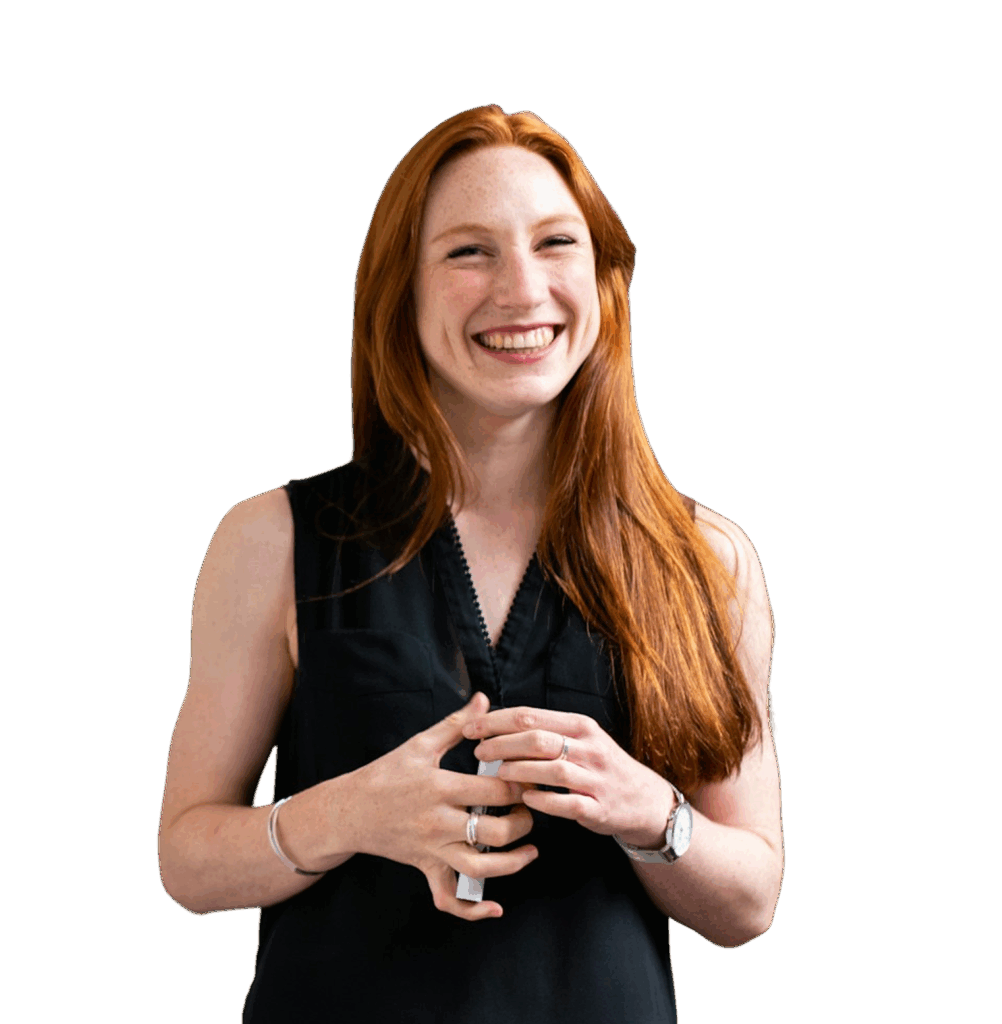 A woman smiles widely in a black, armless office-wear top.
