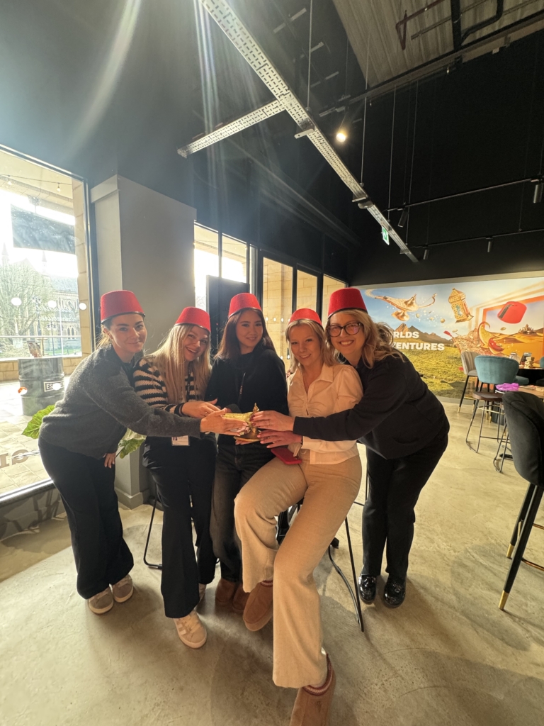 Our winners "Team Aladdin" - a group of 5 women sat closely next to one another holding the magic lamp, in which they saved in the escape room.