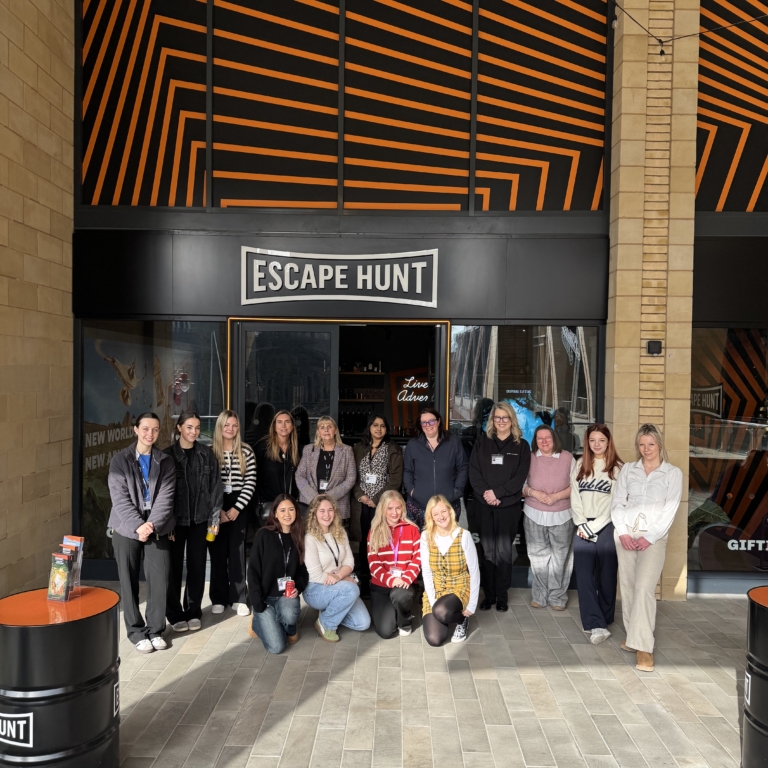 Women from GLP Training standing together for a group photo outside the Escape Hunt venue.