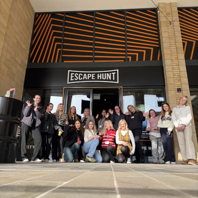 Women from GLP Training standing together for a group photo outside the Escape Hunt venue.