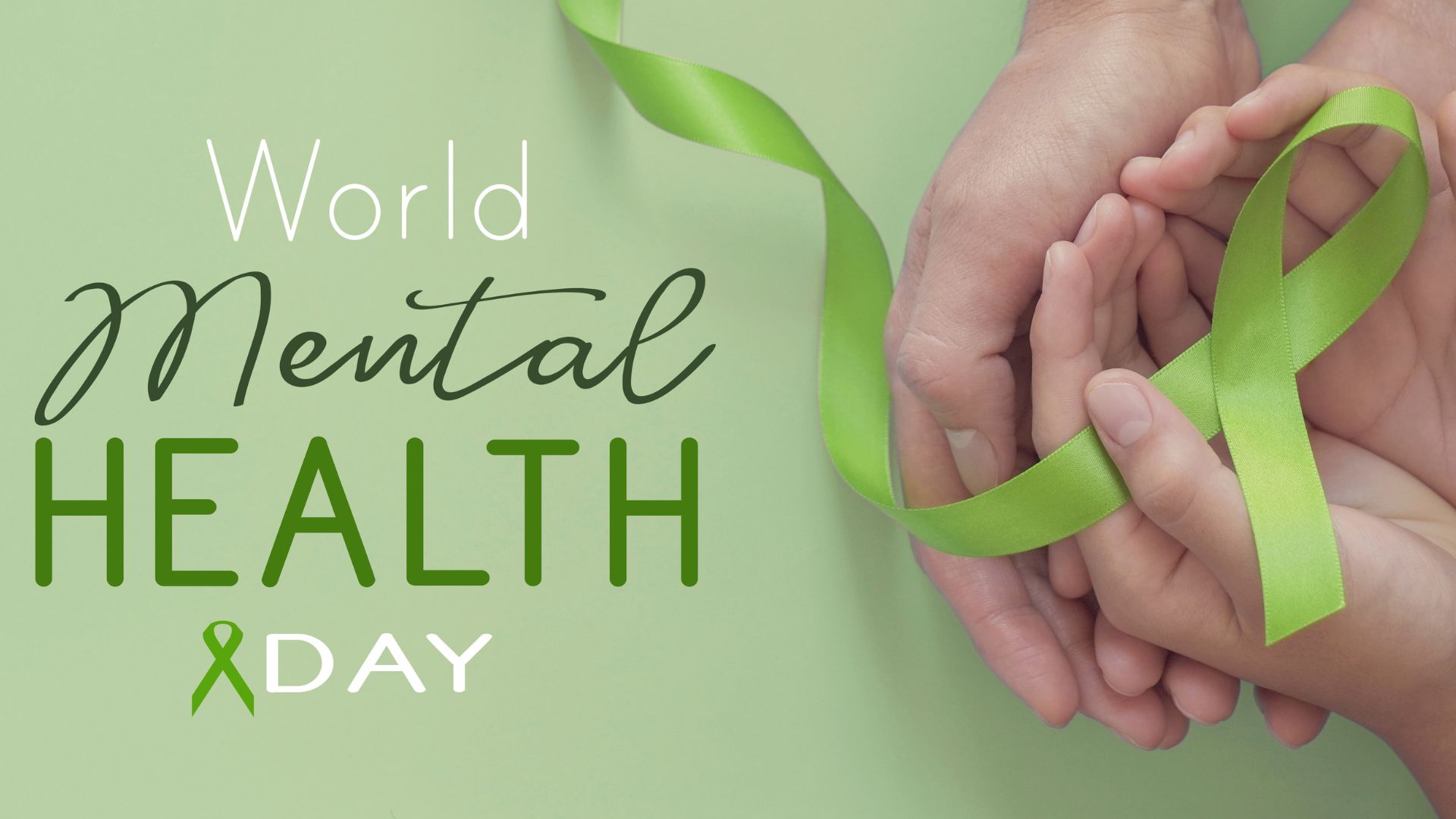 Hand with green ribbon in it to represent mental health