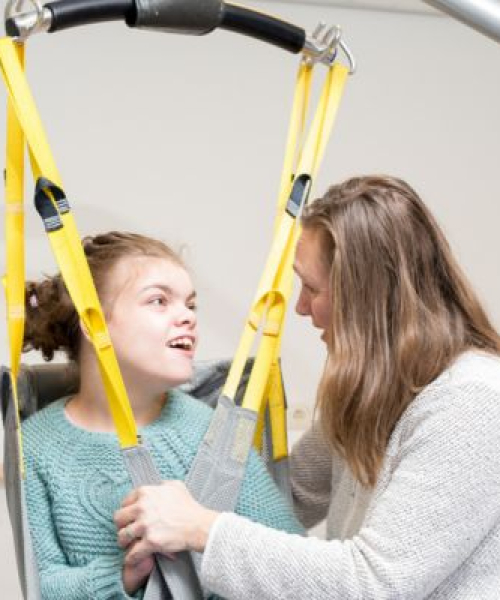 A disabled child being cared for